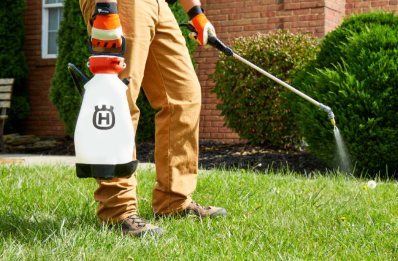 man spraying insecticide grass